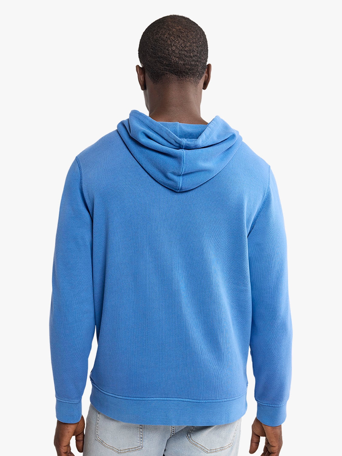 Person wearing a blue hoodie from behind on a white background