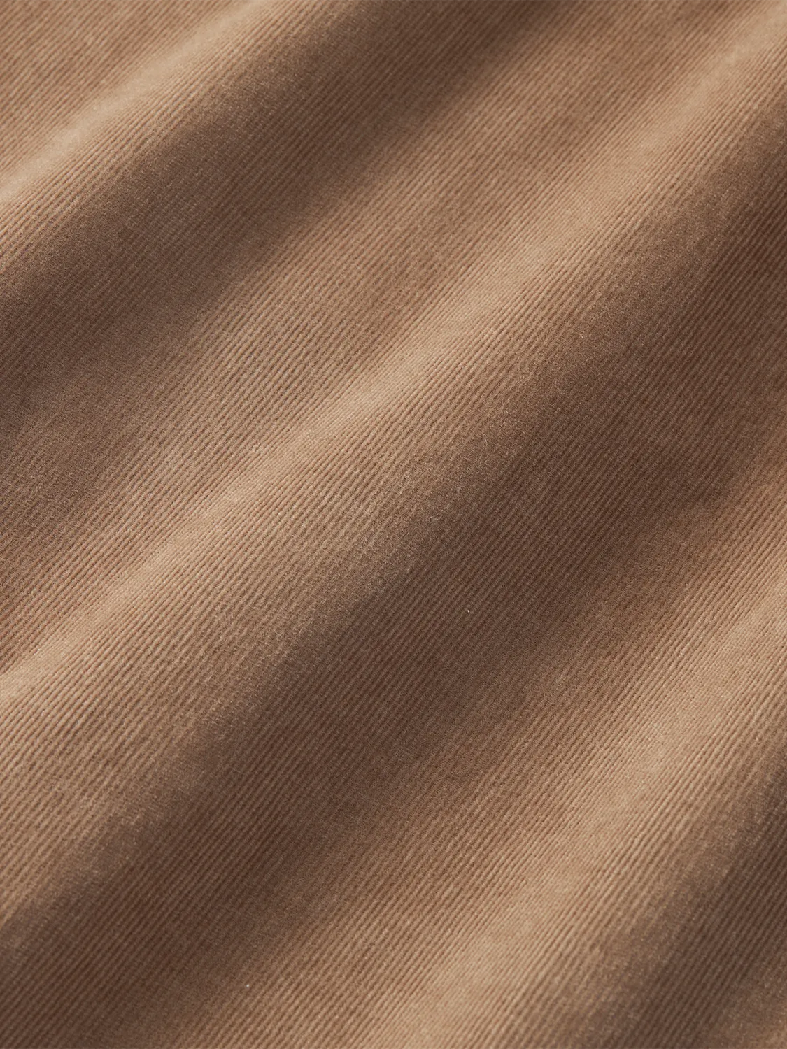 Close-up of brown wilder corduroy shirt fabric.  