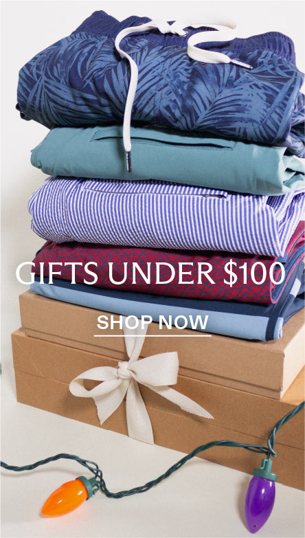 Stack of folded clothes with a gift box and Christmas lights on a white background, with text overlay saying 